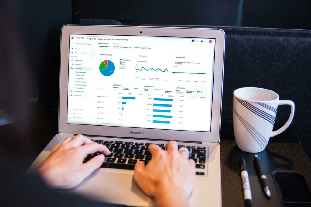 A data analyst reviewing charts and graphs on a digital dashboard